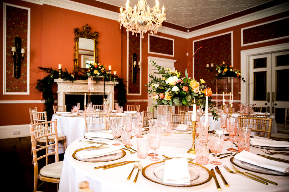 Ballroom at Penton Park set for dinner at a winter wedding with round tables, chiavari chairs and gold tableware