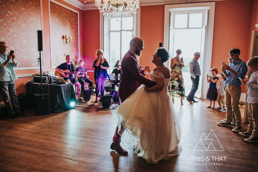Bride and groom dance to live band in Penton Park ballroom