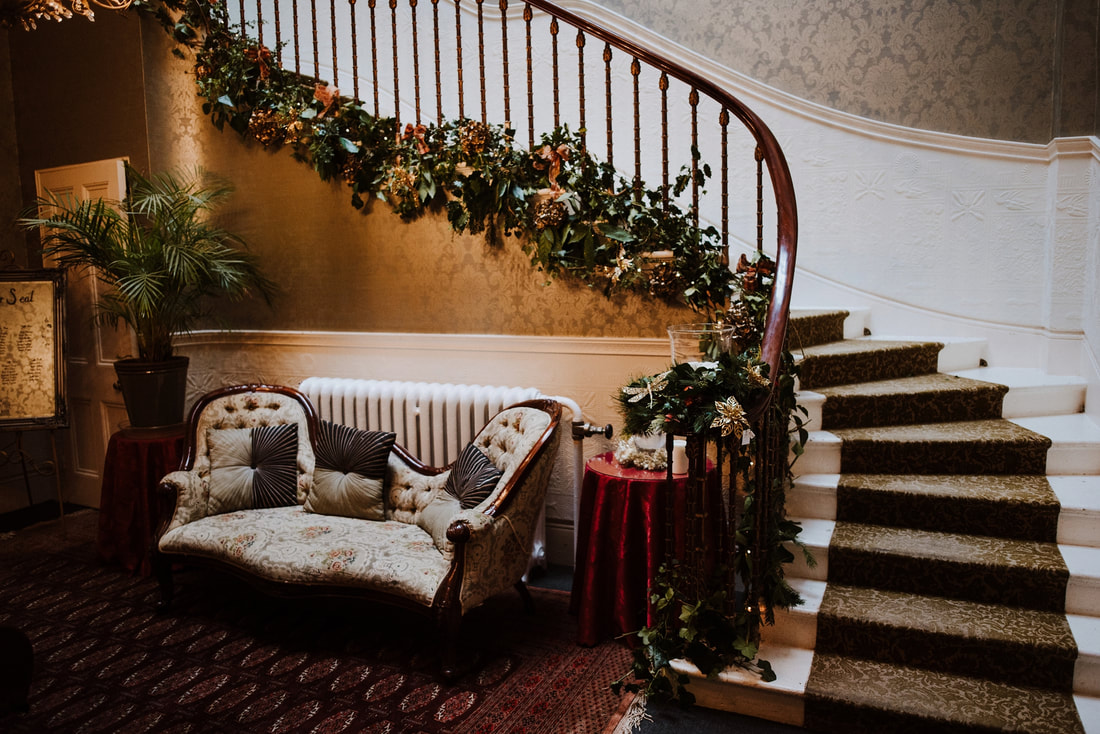 Sofa by staircase at Penton Park at Christmas time