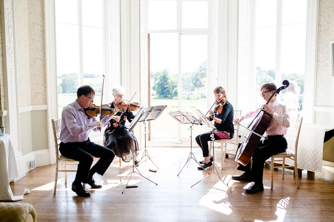 String quartet play in the bay window of the sitting room at Penton Park