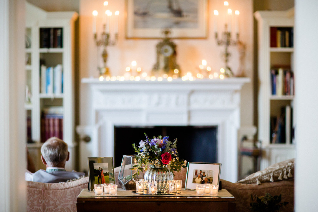 Candles cover the mantelpiece and occasional tables in the sitting room at this Penton Park wedding