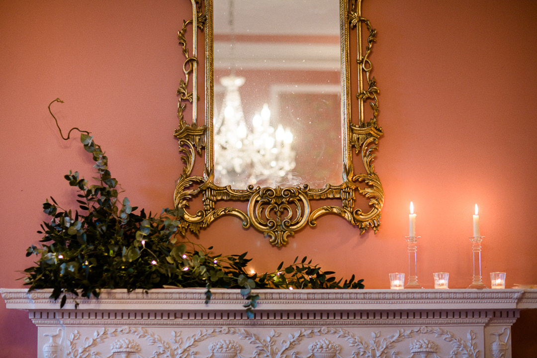 Mantelpiece over the marble fireplace at Penton Park decorated with foliage and candles