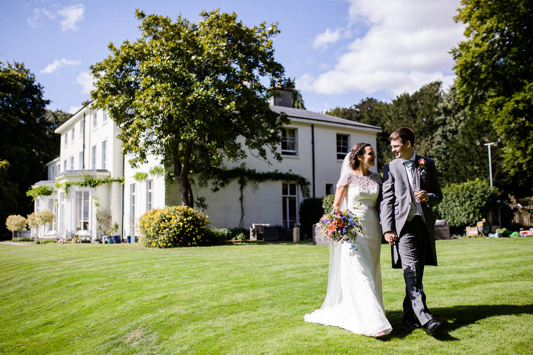 Bride and groom walk in the grounds of Penton Park