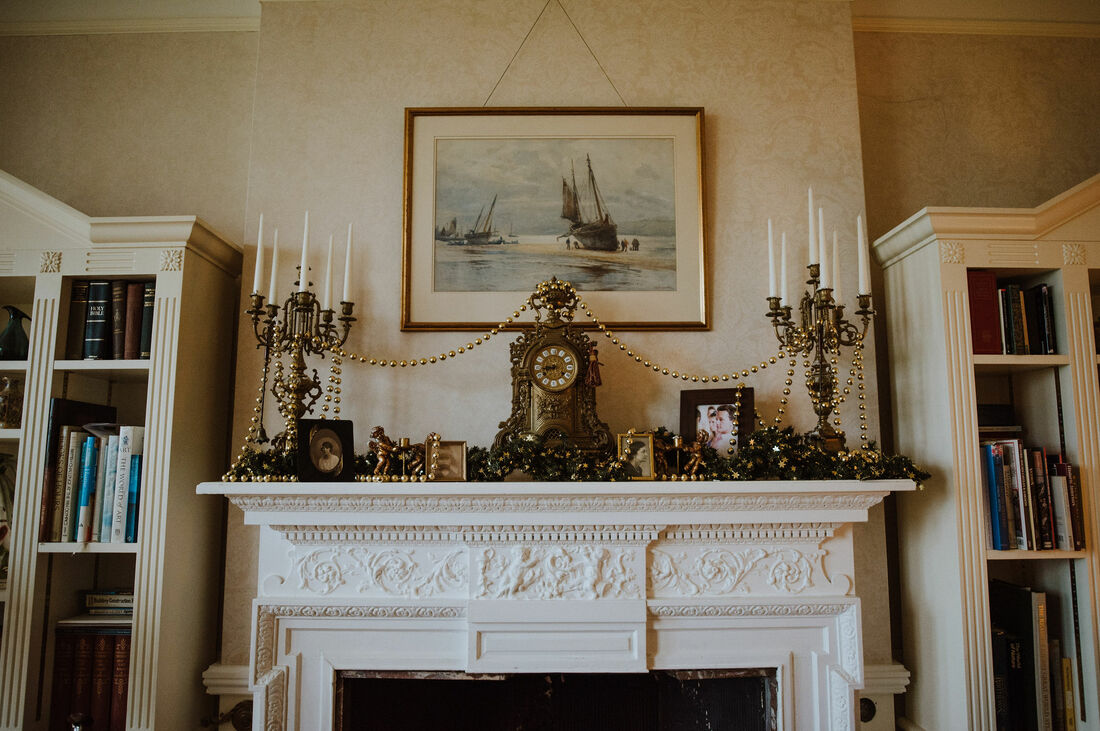 The grand Sitting Room mantlepiece dressed for Christmas at Hampshire wedding venue, Penton Park